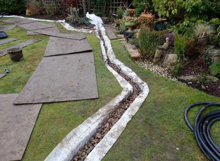 Garden and Lawn Drainage New Malden, Surrey - The lowest side of this garden was prone to flooding due to the lie of the land. Perimeter drainage was installed leading to a sump and pump. Garden Drainage - MDB Landscapes