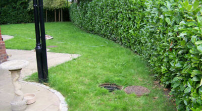 Garden Drainage and New Lawns Claygate, Surrey - A poor soil medium with bad drainage left this garden very difficault to manage and use. Levels were reduced first allowing for the installation of a drainage sytsem followed by a new lawn laid upon new imported soil. Other works here included play areas for the children, tree protection and the raising of Laural hedging due to subsidence. Garden Drainage - MDB Landscapes