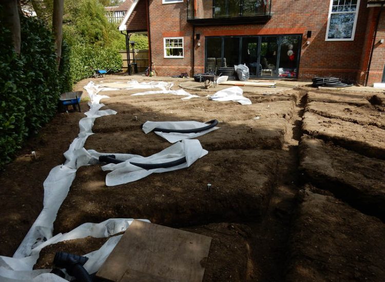Garden Drainage and New Lawns Claygate, Surrey - A poor soil medium with bad drainage left this garden very difficault to manage and use. Levels were reduced first allowing for the installation of a drainage sytsem followed by a new lawn laid upon new imported soil. Other works here included play areas for the children, tree protection and the raising of Laural hedging due to subsidence. Garden Drainage - MDB Landscapes