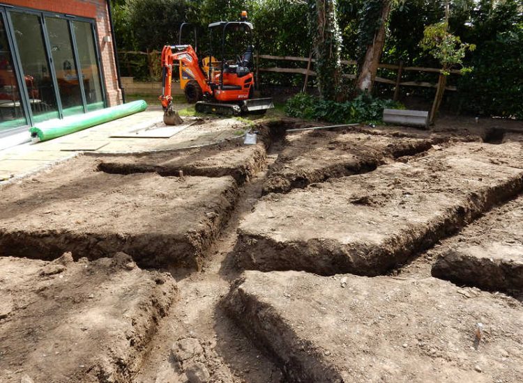 Garden Drainage and New Lawns Claygate, Surrey - A poor soil medium with bad drainage left this garden very difficault to manage and use. Levels were reduced first allowing for the installation of a drainage sytsem followed by a new lawn laid upon new imported soil. Other works here included play areas for the children, tree protection and the raising of Laural hedging due to subsidence. Garden Drainage - MDB Landscapes