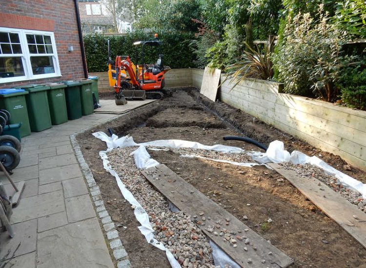Garden Drainage and New Lawns Claygate, Surrey - A poor soil medium with bad drainage left this garden very difficault to manage and use. Levels were reduced first allowing for the installation of a drainage sytsem followed by a new lawn laid upon new imported soil. Other works here included play areas for the children, tree protection and the raising of Laural hedging due to subsidence. Garden Drainage - MDB Landscapes