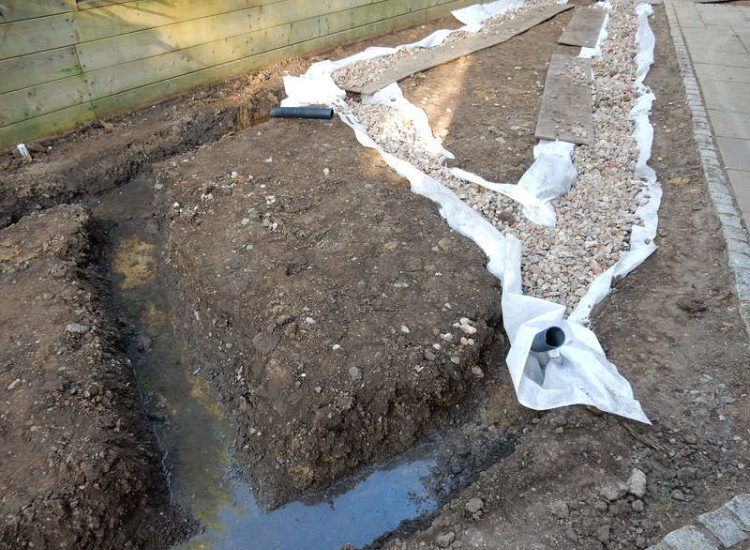 Garden Drainage and New Lawns Claygate, Surrey - A poor soil medium with bad drainage left this garden very difficault to manage and use. Levels were reduced first allowing for the installation of a drainage sytsem followed by a new lawn laid upon new imported soil. Other works here included play areas for the children, tree protection and the raising of Laural hedging due to subsidence. Garden Drainage - MDB Landscapes
