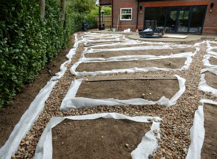 Garden Drainage and New Lawns Claygate, Surrey - A poor soil medium with bad drainage left this garden very difficault to manage and use. Levels were reduced first allowing for the installation of a drainage sytsem followed by a new lawn laid upon new imported soil. Other works here included play areas for the children, tree protection and the raising of Laural hedging due to subsidence. Garden Drainage - MDB Landscapes