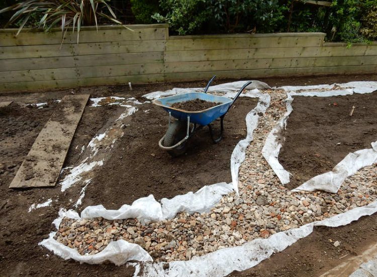 Garden Drainage and New Lawns Claygate, Surrey - A poor soil medium with bad drainage left this garden very difficault to manage and use. Levels were reduced first allowing for the installation of a drainage sytsem followed by a new lawn laid upon new imported soil. Other works here included play areas for the children, tree protection and the raising of Laural hedging due to subsidence. Garden Drainage - MDB Landscapes