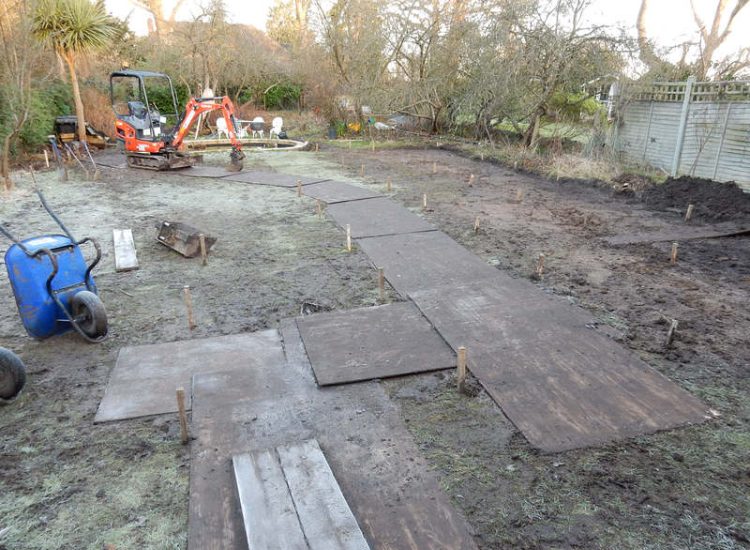 Garden Drainage and New High Specification Lawn Guildford, Surrey - To achieve the requirement of a new lawn extensive drainage was installed via the use of a sump and pump, lawn area was raised with Oak sleeper edging and finally a new lawn laid upon a high end rootzone medium. Garden drainage - MDB Landscapes