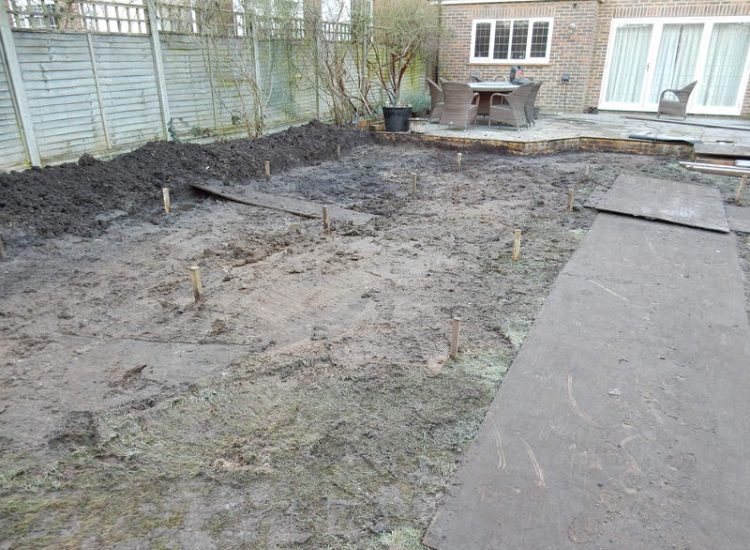 Garden Drainage and New High Specification Lawn Guildford, Surrey - To achieve the requirement of a new lawn extensive drainage was installed via the use of a sump and pump, lawn area was raised with Oak sleeper edging and finally a new lawn laid upon a high end rootzone medium. Garden drainage - MDB Landscapes