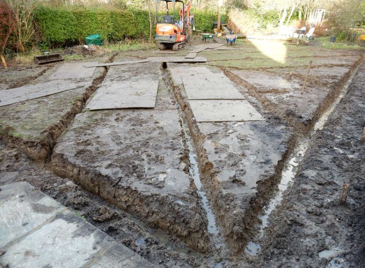 Garden Drainage and New High Specification Lawn Guildford, Surrey - To achieve the requirement of a new lawn extensive drainage was installed via the use of a sump and pump, lawn area was raised with Oak sleeper edging and finally a new lawn laid upon a high end rootzone medium. Garden drainage - MDB Landscapes