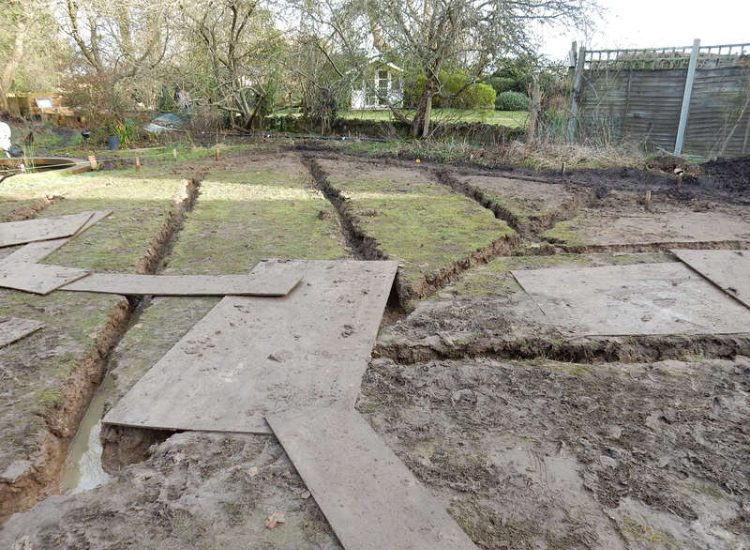 Garden Drainage and New High Specification Lawn Guildford, Surrey - To achieve the requirement of a new lawn extensive drainage was installed via the use of a sump and pump, lawn area was raised with Oak sleeper edging and finally a new lawn laid upon a high end rootzone medium. Garden drainage - MDB Landscapes