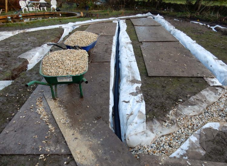 Garden Drainage and New High Specification Lawn Guildford, Surrey - To achieve the requirement of a new lawn extensive drainage was installed via the use of a sump and pump, lawn area was raised with Oak sleeper edging and finally a new lawn laid upon a high end rootzone medium. Garden drainage - MDB Landscapes