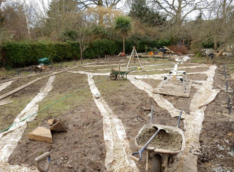 Garden Drainage and New High Specification Lawn Guildford, Surrey - To achieve the requirement of a new lawn extensive drainage was installed via the use of a sump and pump, lawn area was raised with Oak sleeper edging and finally a new lawn laid upon a high end rootzone medium. Garden drainage - MDB Landscapes