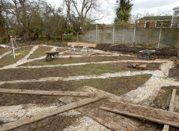 Garden Drainage and New High Specification Lawn Guildford, Surrey - To achieve the requirement of a new lawn extensive drainage was installed via the use of a sump and pump, lawn area was raised with Oak sleeper edging and finally a new lawn laid upon a high end rootzone medium. Garden drainage - MDB Landscapes