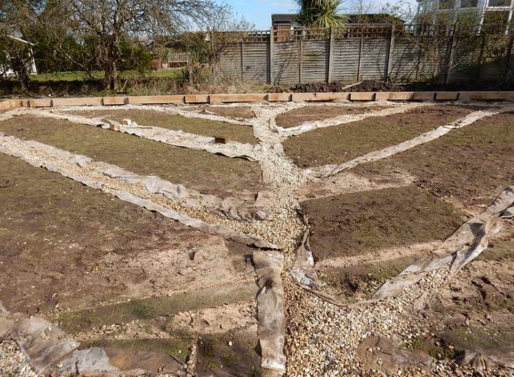 Garden Drainage and New High Specification Lawn Guildford, Surrey - To achieve the requirement of a new lawn extensive drainage was installed via the use of a sump and pump, lawn area was raised with Oak sleeper edging and finally a new lawn laid upon a high end rootzone medium. Garden drainage - MDB Landscapes