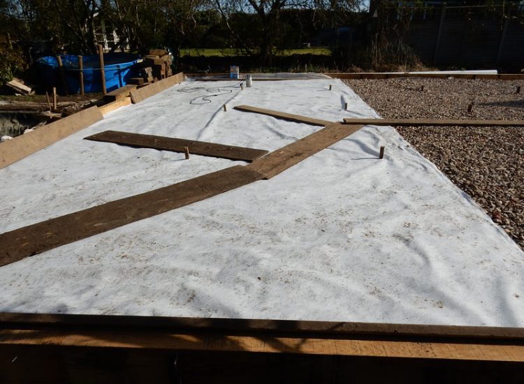 Garden Drainage and New High Specification Lawn Guildford, Surrey - To achieve the requirement of a new lawn extensive drainage was installed via the use of a sump and pump, lawn area was raised with Oak sleeper edging and finally a new lawn laid upon a high end rootzone medium. Garden drainage - MDB Landscapes