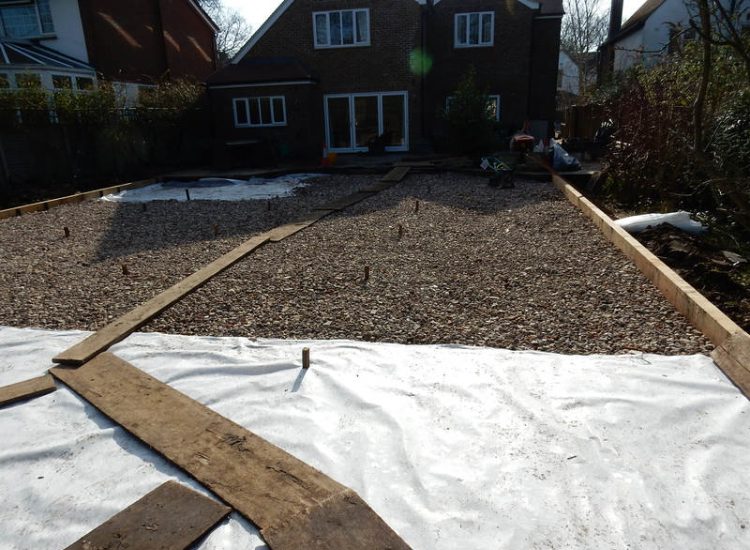 Garden Drainage and New High Specification Lawn Guildford, Surrey - To achieve the requirement of a new lawn extensive drainage was installed via the use of a sump and pump, lawn area was raised with Oak sleeper edging and finally a new lawn laid upon a high end rootzone medium. Garden drainage - MDB Landscapes