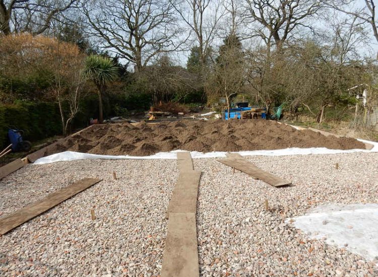 Garden Drainage and New High Specification Lawn Guildford, Surrey - To achieve the requirement of a new lawn extensive drainage was installed via the use of a sump and pump, lawn area was raised with Oak sleeper edging and finally a new lawn laid upon a high end rootzone medium. Garden drainage - MDB Landscapes