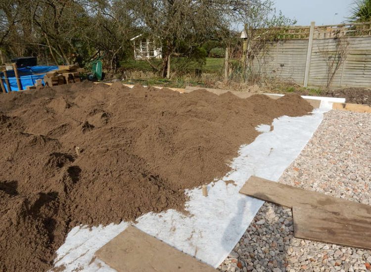 Garden Drainage and New High Specification Lawn Guildford, Surrey - To achieve the requirement of a new lawn extensive drainage was installed via the use of a sump and pump, lawn area was raised with Oak sleeper edging and finally a new lawn laid upon a high end rootzone medium. Garden drainage - MDB Landscapes
