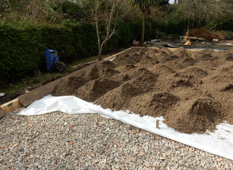 Garden Drainage and New High Specification Lawn Guildford, Surrey - To achieve the requirement of a new lawn extensive drainage was installed via the use of a sump and pump, lawn area was raised with Oak sleeper edging and finally a new lawn laid upon a high end rootzone medium. Garden drainage - MDB Landscapes