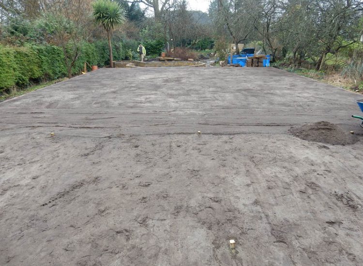 Garden Drainage and New High Specification Lawn Guildford, Surrey - To achieve the requirement of a new lawn extensive drainage was installed via the use of a sump and pump, lawn area was raised with Oak sleeper edging and finally a new lawn laid upon a high end rootzone medium. Garden drainage - MDB Landscapes