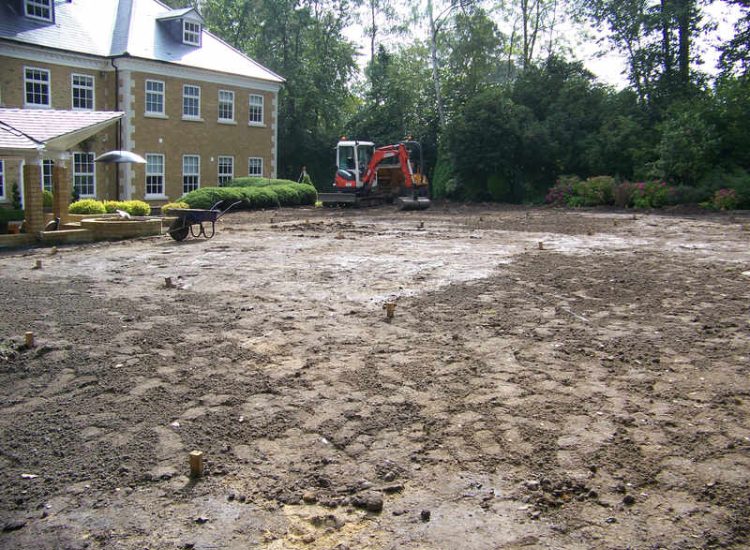 Lawn Drainage Cobham, Surrey - A poor soil medium for both front and rear gardens left lawn areas very water logged and difficult to manage. Extensive land drainage was installed, new rootzone medium imported in and lawns re-turfed. Garden Drainage - MDB Landscapes