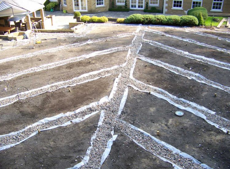 Lawn Drainage Cobham, Surrey - A poor soil medium for both front and rear gardens left lawn areas very water logged and difficult to manage. Extensive land drainage was installed, new rootzone medium imported in and lawns re-turfed. Garden Drainage - MDB Landscapes