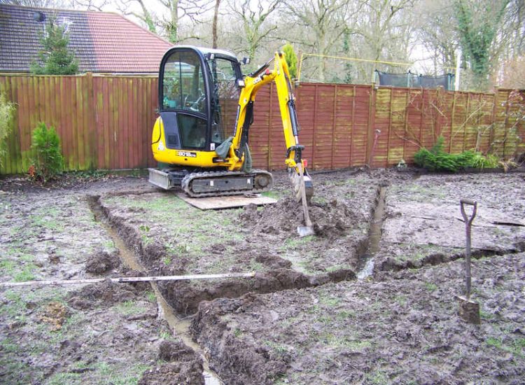 Lawn Drainage in Winchester, Hampshire - Low lawn levels and a poor soil type required the raising of levels with the use of drainage layers and land drains for this water logged garden and lawn. Imported soil was used to raise levels and all areas re-turfed. Garden Drainage - MDB Landscapes