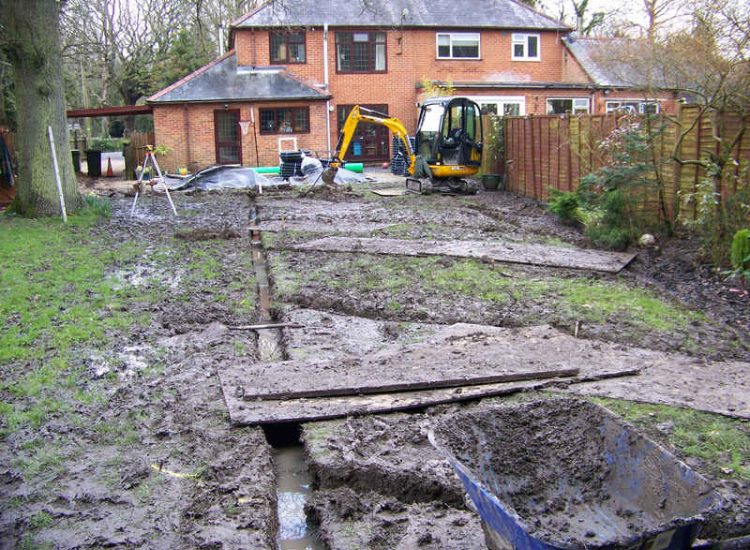 Lawn Drainage in Winchester, Hampshire - Low lawn levels and a poor soil type required the raising of levels with the use of drainage layers and land drains for this water logged garden and lawn. Imported soil was used to raise levels and all areas re-turfed. Garden Drainage - MDB Landscapes