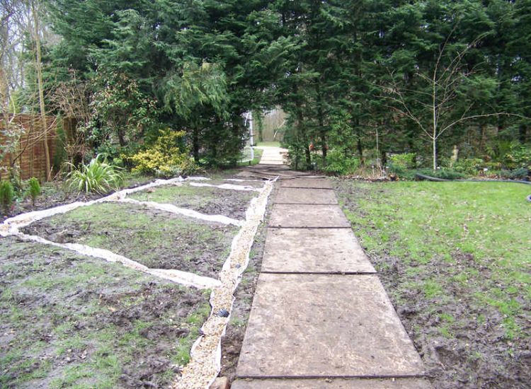 Lawn Drainage in Winchester, Hampshire - Low lawn levels and a poor soil type required the raising of levels with the use of drainage layers and land drains for this water logged garden and lawn. Imported soil was used to raise levels and all areas re-turfed. Garden Drainage - MDB Landscapes