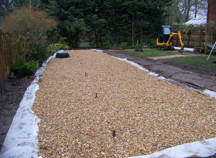 Lawn Drainage in Winchester, Hampshire - Low lawn levels and a poor soil type required the raising of levels with the use of drainage layers and land drains for this water logged garden and lawn. Imported soil was used to raise levels and all areas re-turfed. Garden Drainage - MDB Landscapes