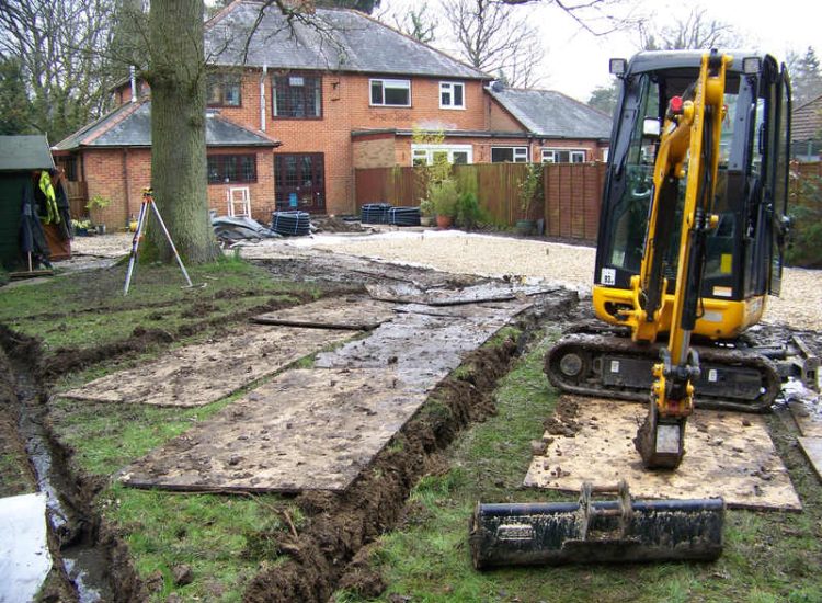 Lawn Drainage in Winchester, Hampshire - Low lawn levels and a poor soil type required the raising of levels with the use of drainage layers and land drains for this water logged garden and lawn. Imported soil was used to raise levels and all areas re-turfed. Garden Drainage - MDB Landscapes