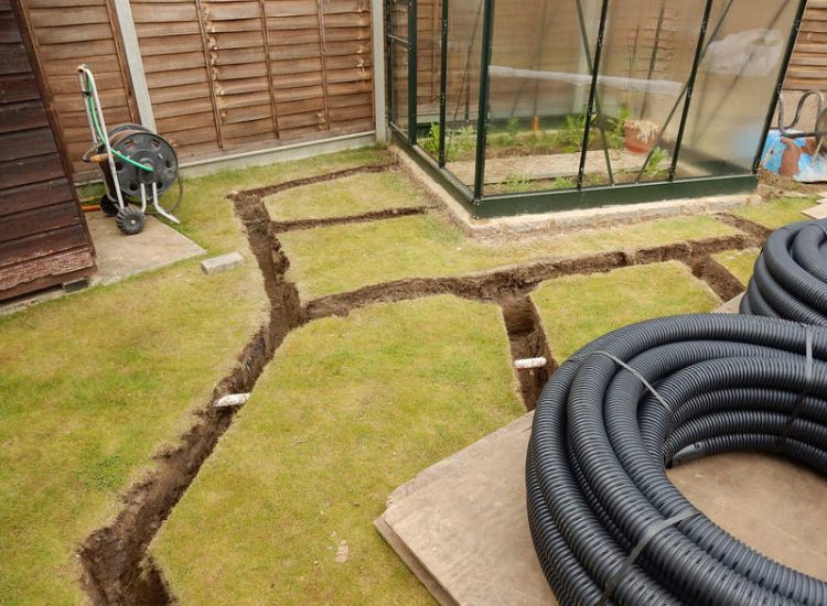 Garden and Lawn Drainage Wokingham, Berkshire - Unusable flooded planting areas, a flooded glass house and a very wet lawn prevented this client from enjoying their garden. Drainage was installed running through the glass house as well. Garden Drainage - MDB Landscapes