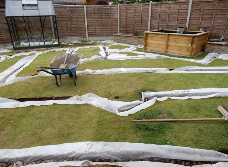 Garden and Lawn Drainage Wokingham, Berkshire - Unusable flooded planting areas, a flooded glass house and a very wet lawn prevented this client from enjoying their garden. Drainage was installed running through the glass house as well. Garden Drainage - MDB Landscapes