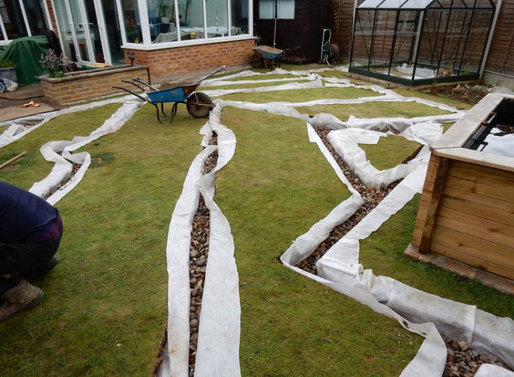 Garden and Lawn Drainage Wokingham, Berkshire - Unusable flooded planting areas, a flooded glass house and a very wet lawn prevented this client from enjoying their garden. Drainage was installed running through the glass house as well. Garden Drainage - MDB Landscapes