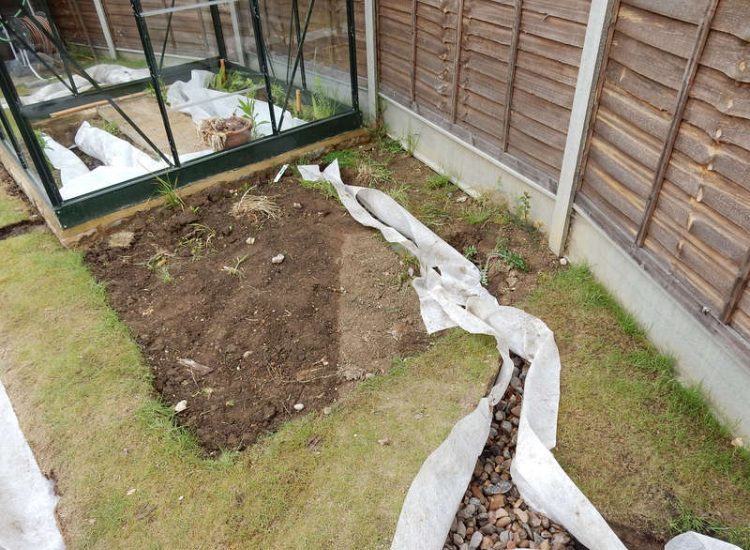 Garden and Lawn Drainage Wokingham, Berkshire - Unusable flooded planting areas, a flooded glass house and a very wet lawn prevented this client from enjoying their garden. Drainage was installed running through the glass house as well. Garden Drainage - MDB Landscapes