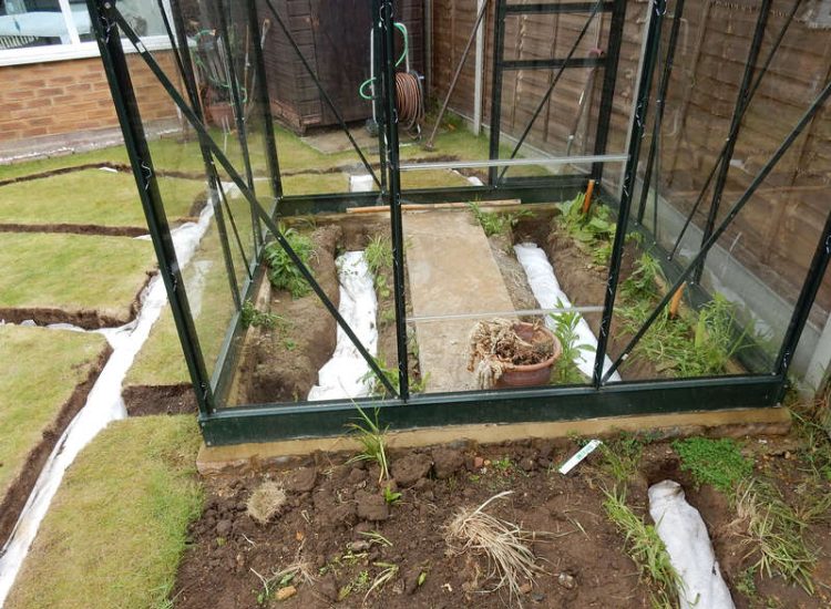 Garden and Lawn Drainage Wokingham, Berkshire - Unusable flooded planting areas, a flooded glass house and a very wet lawn prevented this client from enjoying their garden. Drainage was installed running through the glass house as well. Garden Drainage - MDB Landscapes