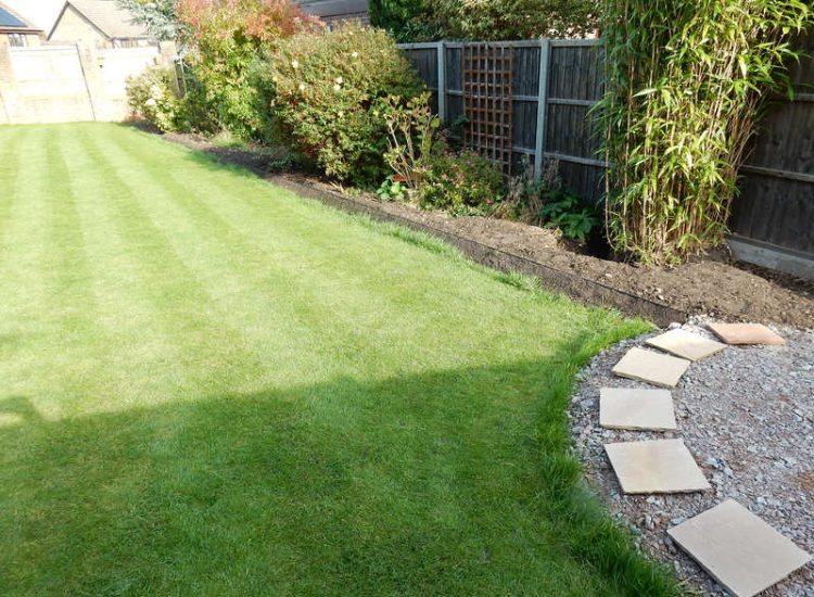 Turfing in Lightwater, Surrey - A new lawn raised to new levels, flush to new EverEdge Pro edging and paved areas. Imported soil medium a blend of topsoil, organic matter and sand. Turf used Rolawn Medallion. Lawns & Turfing - MDB Landscapes