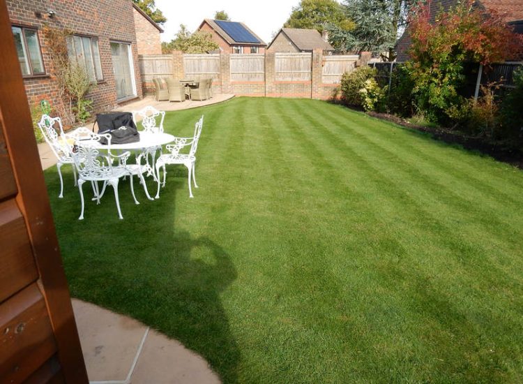 Turfing in Lightwater, Surrey - A new lawn raised to new levels, flush to new EverEdge Pro edging and paved areas. Imported soil medium a blend of topsoil, organic matter and sand. Turf used Rolawn Medallion. Lawns & Turfing - MDB Landscapes