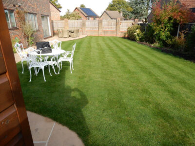 Turfing in Lightwater, Surrey - A new lawn raised to new levels, flush to new EverEdge Pro edging and paved areas. Imported soil medium a blend of topsoil, organic matter and sand. Turf used Rolawn Medallion. Lawns & Turfing - MDB Landscapes