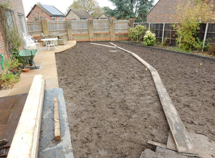 Turfing in Lightwater, Surrey - A new lawn raised to new levels, flush to new EverEdge Pro edging and paved areas. Imported soil medium a blend of topsoil, organic matter and sand. Turf used Rolawn Medallion. Lawns & Turfing - MDB Landscapes