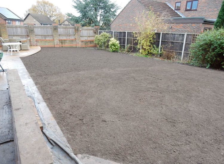 Turfing in Lightwater, Surrey - A new lawn raised to new levels, flush to new EverEdge Pro edging and paved areas. Imported soil medium a blend of topsoil, organic matter and sand. Turf used Rolawn Medallion. Lawns & Turfing - MDB Landscapes