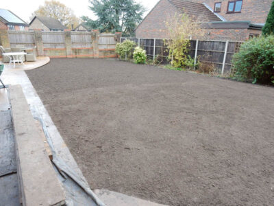 Turfing in Lightwater, Surrey - A new lawn raised to new levels, flush to new EverEdge Pro edging and paved areas. Imported soil medium a blend of topsoil, organic matter and sand. Turf used Rolawn Medallion. Lawns & Turfing - MDB Landscapes