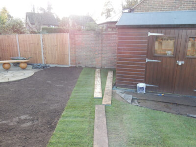 Turfing in Lightwater, Surrey - A new lawn raised to new levels, flush to new EverEdge Pro edging and paved areas. Imported soil medium a blend of topsoil, organic matter and sand. Turf used Rolawn Medallion. Lawns & Turfing - MDB Landscapes