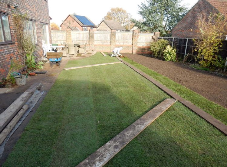 Turfing in Lightwater, Surrey - A new lawn raised to new levels, flush to new EverEdge Pro edging and paved areas. Imported soil medium a blend of topsoil, organic matter and sand. Turf used Rolawn Medallion. Lawns & Turfing - MDB Landscapes