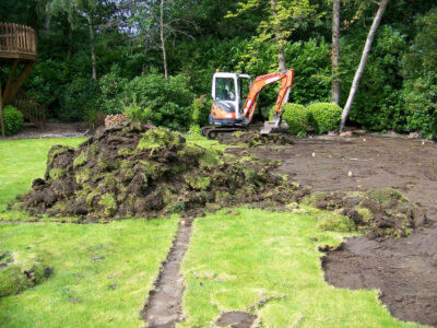 Lawn Construction in Oxshott, Surrey - Large areas of garden lawns struggling with drainage issues. Areas reduced in levels first, land drainage installed followed by the importaion of rootzone and completed areas re-turfed. Lawns & Turfing - MDB Landscapes