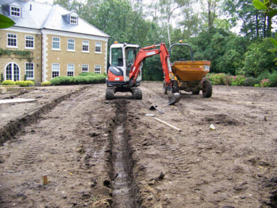 Lawn Construction in Oxshott, Surrey - Large areas of garden lawns struggling with drainage issues. Areas reduced in levels first, land drainage installed followed by the importaion of rootzone and completed areas re-turfed. Lawns & Turfing - MDB Landscapes