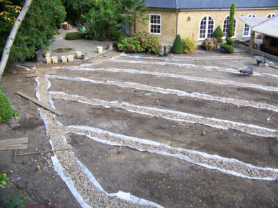 Lawn Construction in Oxshott, Surrey - Large areas of garden lawns struggling with drainage issues. Areas reduced in levels first, land drainage installed followed by the importaion of rootzone and completed areas re-turfed. Lawns & Turfing - MDB Landscapes