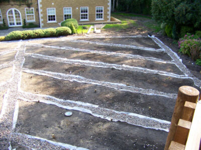 Lawn Construction in Oxshott, Surrey - Large areas of garden lawns struggling with drainage issues. Areas reduced in levels first, land drainage installed followed by the importaion of rootzone and completed areas re-turfed. Lawns & Turfing - MDB Landscapes