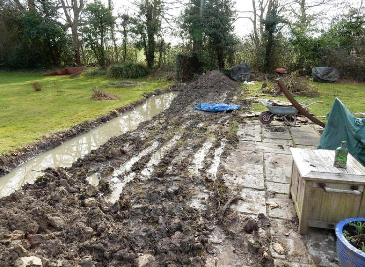 Planting Border Drainage Cranleigh, Surrey - To aid reinstatement of a new boundary hedge a bold drainage solution was required incorporating drainage layers, land drains and the use of a sump and pump. Garden drainage - MDB Landscapes