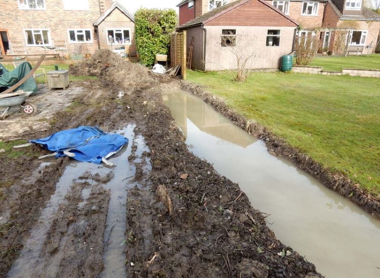 Planting Border Drainage Cranleigh, Surrey - To aid reinstatement of a new boundary hedge a bold drainage solution was required incorporating drainage layers, land drains and the use of a sump and pump. Garden drainage - MDB Landscapes