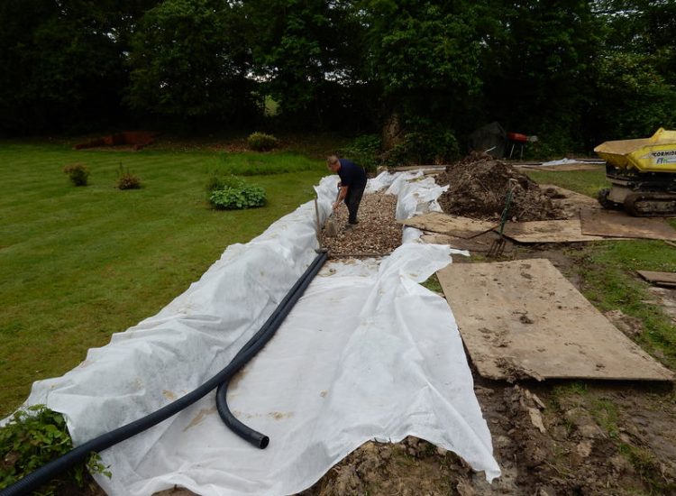 Planting Border Drainage Cranleigh, Surrey - To aid reinstatement of a new boundary hedge a bold drainage solution was required incorporating drainage layers, land drains and the use of a sump and pump. Garden drainage - MDB Landscapes
