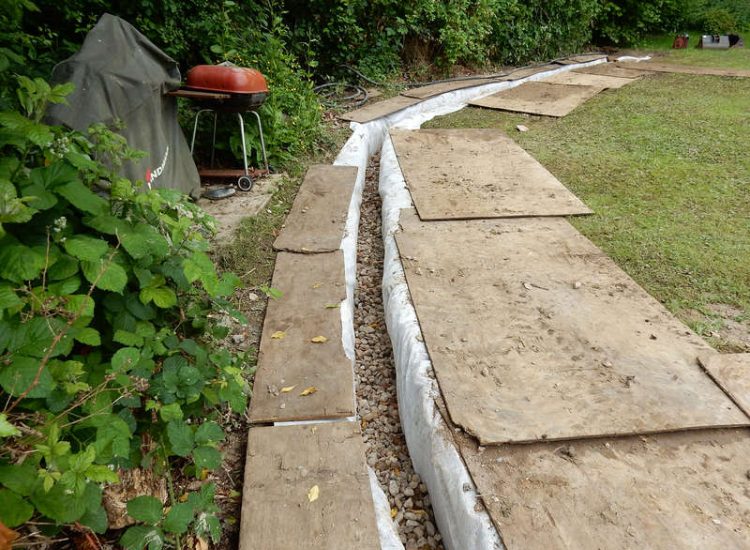Planting Border Drainage Cranleigh, Surrey - To aid reinstatement of a new boundary hedge a bold drainage solution was required incorporating drainage layers, land drains and the use of a sump and pump. Garden drainage - MDB Landscapes